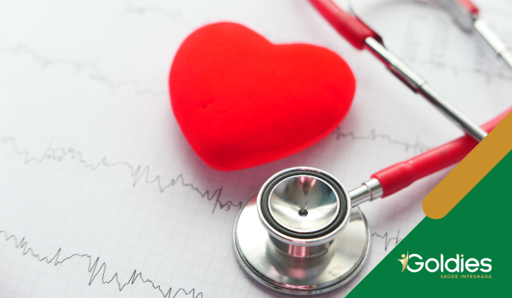 Um coração de pelúcia vermelho e estetoscópio em uma impressão de eletrocardiograma ilustrando o artigo "Pressão Arterial no Inverno: Cuidados Essenciais para o Controle"
